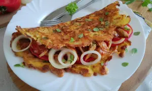 Placki z marchewki z pomidorami i cebulą, posypane oregano. Pyszne i zdrowe danie.