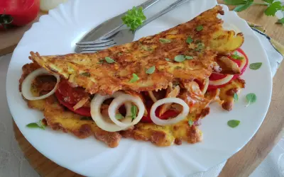 Placki z marchewki z pomidorami i cebulą, posypane oregano. Pyszne i zdrowe danie.